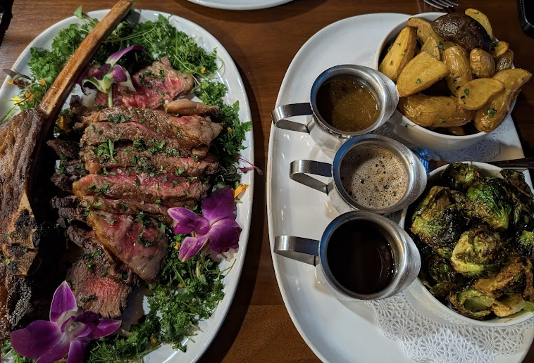 The Whistling Grizzly signature dishes Day Aged Bison TomahawkKurobuta Pork ChopTrout